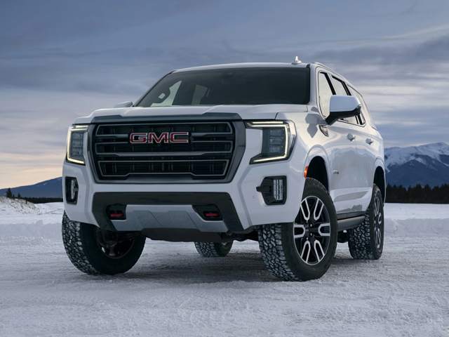 A white 2024 GMC Yukon parked on snowy ground