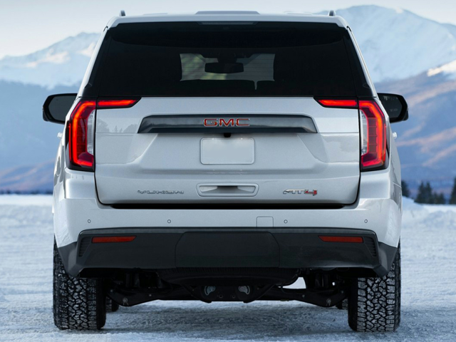 rear view of a white 2024 GMC Yukon parked on snowy terrain