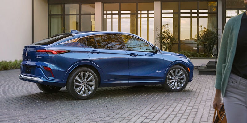 Passenger side view of a blue 2024 Buick Envista parked in a driveway